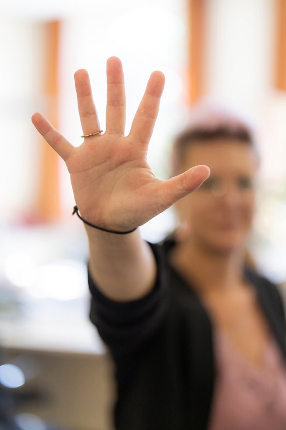 Stop jemand streckt eine Hand in die Kamera mit gespreizten Fingern
